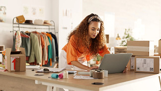 Woman on computer optimizing logistics outsourcing